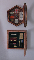 A glass front cabinet displaying 
antique razors